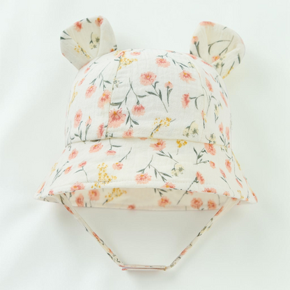 Chapeau de soleil Le Cocon d'Or pour bébé en coton blanc avec motif floral ditsy et oreilles d'ours décoratives