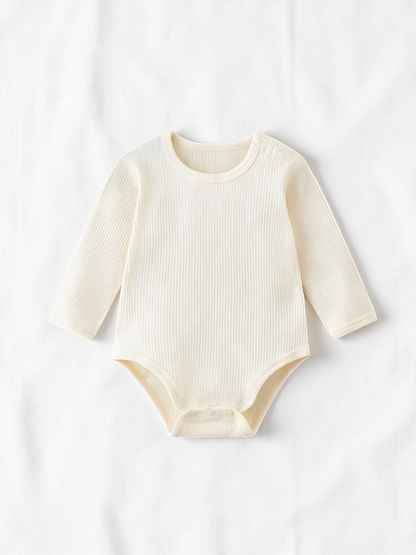 Body bébé Le Cocon d'Or en coton côtelé beige à manches longues, col rond et boutons pression pour un change facile