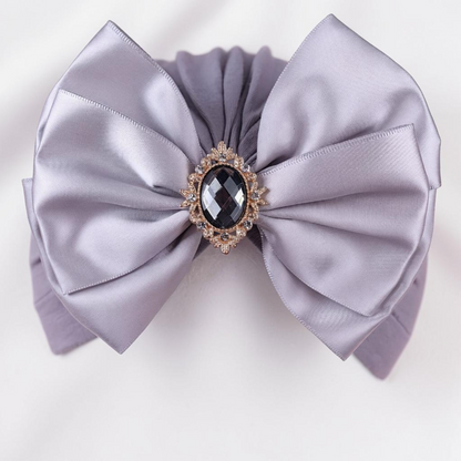 Chapeau turban gris Le Cocon d'Or pour bébé avec un grand nœud en satin et une broche centrale en cristal noir