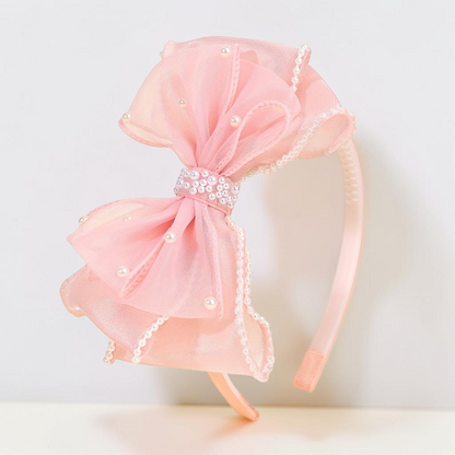 Serre-tête Le Cocon d'Or rose en tulle avec un grand nœud orné de perles, accessoire élégant pour coiffure festive