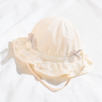 Chapeau de pêcheur blanc Le Cocon d'Or pour bébé en dentelle respirante avec nœuds décoratifs et bordure à volants