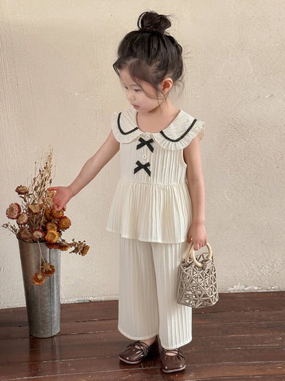 Ensemble 2 pièces pour petites filles, haut sans manches à col Peter Pan avec volants + pantalon large à texture, tenue décontractée d'été, ensemble de pantalons longs à la mode et ludiques pour filles, convient pour les sorties, les séances photo et les