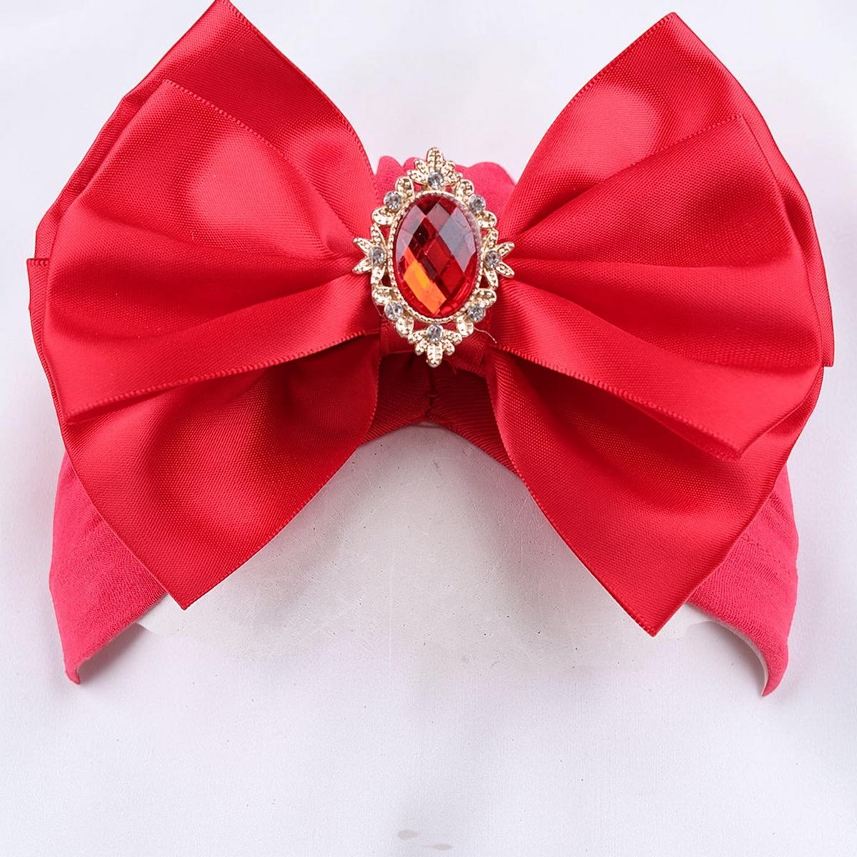 Bandeau bébé Le Cocon d'Or rouge en polyester avec un grand nœud décoratif et une pierre précieuse centrale