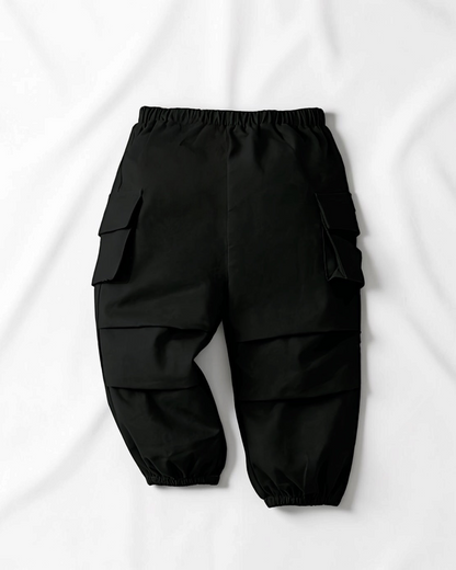 Pantalon cargo noir en coton pour fille Le Cocon d'Or avec poches latérales et chevilles élastiques