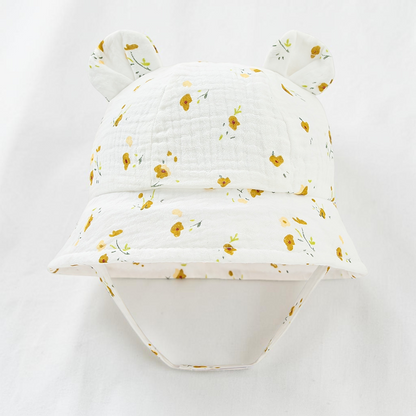 Chapeau de soleil Le Cocon d'Or pour bébé en coton blanc avec motif fleurs ditsy et petites oreilles décoratives
