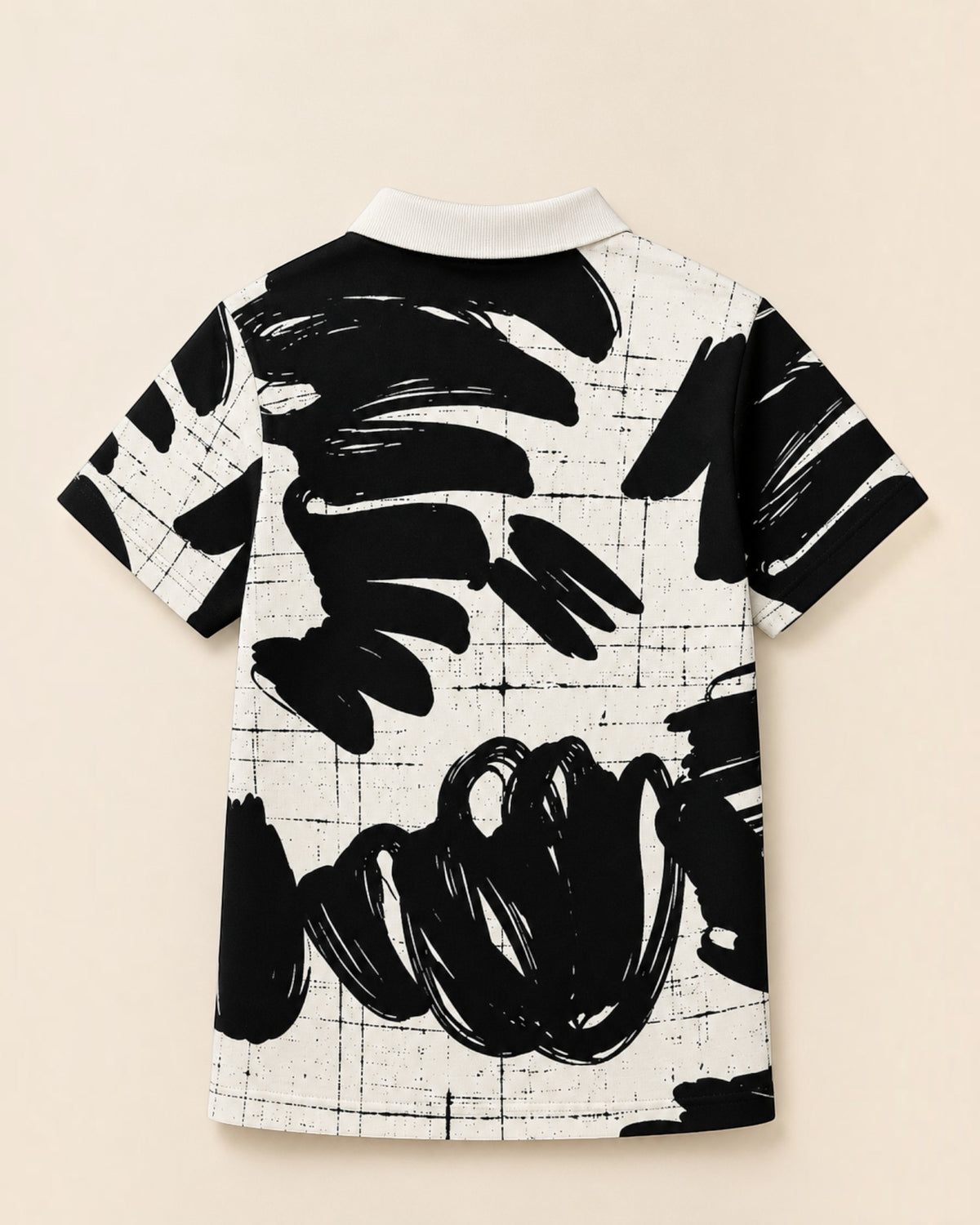 Vue arrière du polo Le Cocon d'Or pour garçon avec motif abstrait noir et blanc et col classique