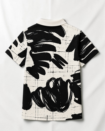 Vue arrière du polo Le Cocon d'Or pour garçon avec motif abstrait noir et blanc et col classique