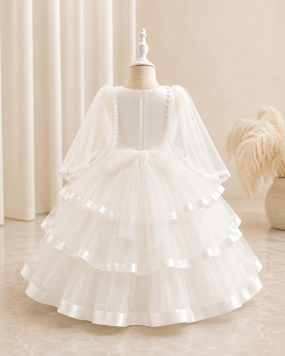 Robe midi blanche pour fille Le Cocon d'Or avec manches bouffantes en tulle, détails perlés et jupe évasée à volants.